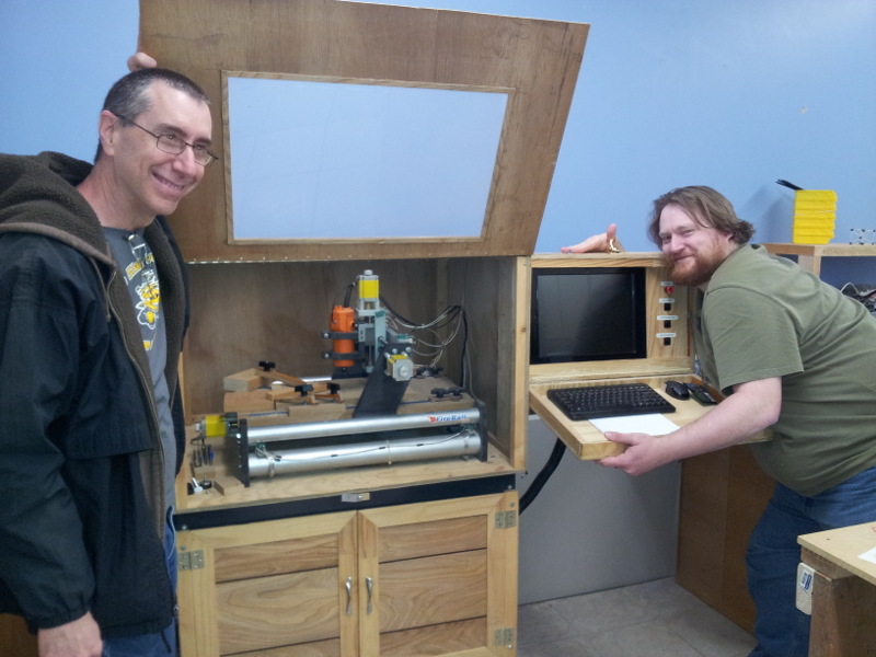 Tom and James posing with the CNC machine